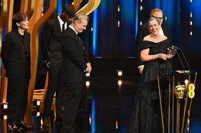 Cillian Murphy, Christopher Nolan, Charles Roven and Emma Thomas accept the Best Film Award for 'Oppenheimer' on stage during the EE BAFTA Film Awards 2024