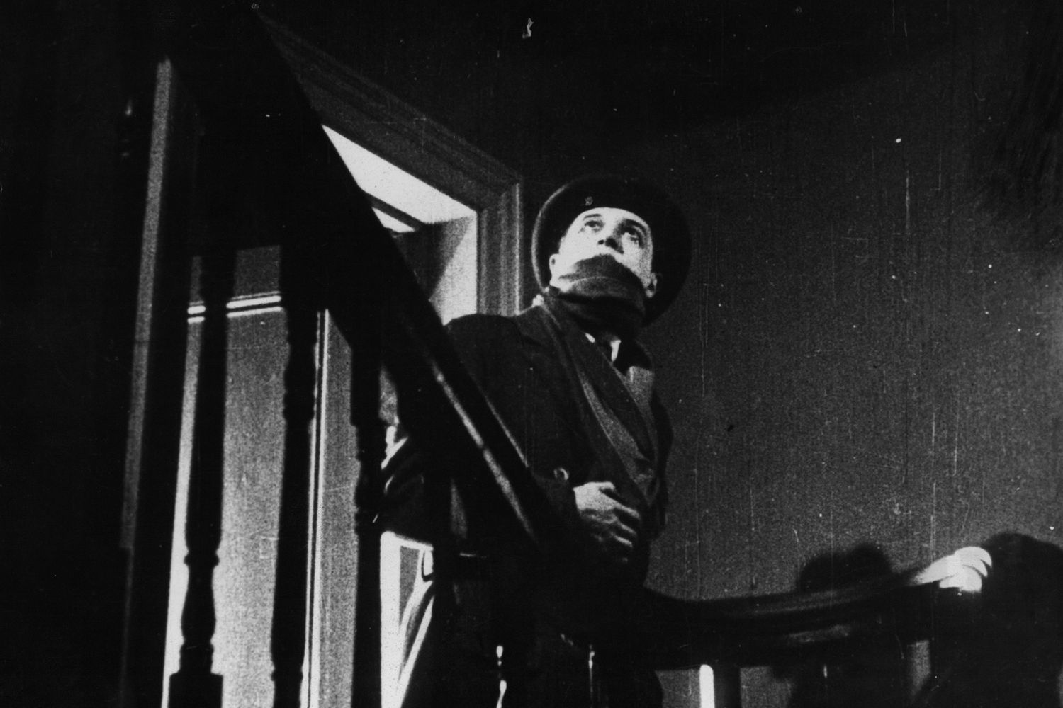 Ivor Novello looks up the stairs in a scene from the film 'The Lodger: A Story Of The London Fog', 1927. (Photo by AmerAnglo/Getty Images)