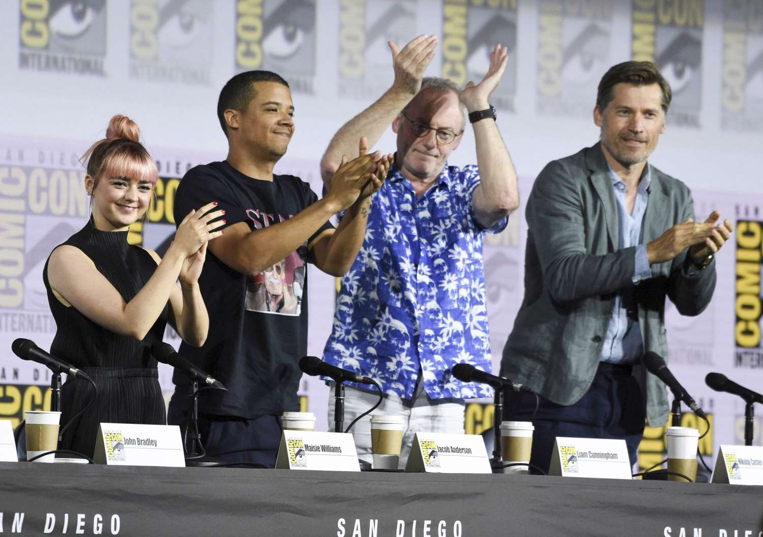 Mandatory Credit: Photo by Chris Pizzello/Invision/AP/Shutterstock (10342108a) Maisie Williams, Jacob Anderson, Liam Cunningham, Nikolaj Coster-Waldau. Maisie Williams, from left, Jacob Anderson, Liam Cunningham and Nikolaj Coster-Waldau clap at the conclusion of the "Game of Thrones" panel on day two of Comic-Con International, in San Diego 2019 Comic-Con - "Game of Thrones" Panel, San Diego, USA - 19 Jul 2019