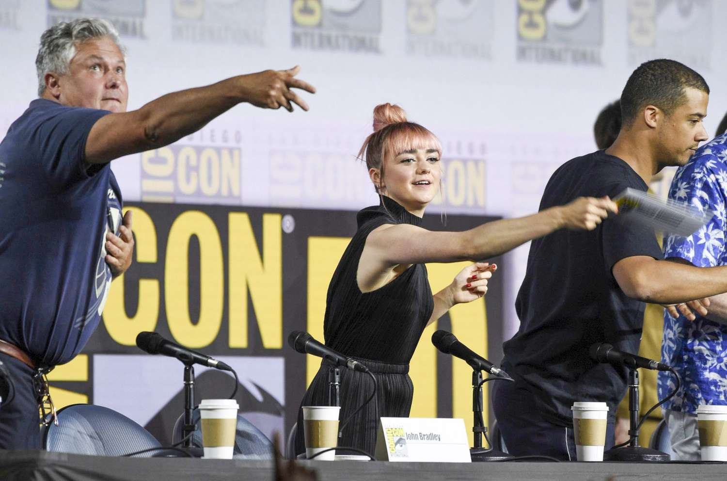 Mandatory Credit: Photo by Chris Pizzello/Invision/AP/Shutterstock (10342099k) Conleth Hill, Maisie Williams, Jacob Anderson. Conleth Hill, from left, Maisie Williams and Jacob Anderson throw their name card to the audience at the conclusion of the "Game of Thrones" panel on day two of Comic-Con International, in San Diego 2019 Comic-Con - "Game of Thrones" Panel, San Diego, USA - 19 Jul 2019