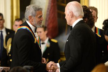 Joe Biden, right, greets actor George Clooney during the Kennedy Center honoree reception