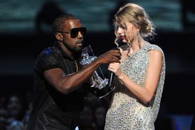 Kanye West (L) jumps onstage after Taylor Swift (C) won the "Best Female Video" award during the 2009 MTV Video Music Awards at Radio City Music Hall on September 13, 2009 in New York City. 