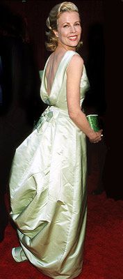 Oscars 1998, Kim Basinger | 17. KIM BASINGER (1998) To pick up her Best Supporting Actress statuette for the '50s-era flick L.A. Confidential , Basinger picked an appropriately retro-chic Escada.