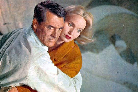 Cary Grant holding Eva Marie Saint in a scene from the film 'North By Northwest', 1959. Grant is wearing a pale grey Oxford shirt by Brooks Brothers. (Photo by Metro-Goldwyn-Mayer/Getty Images)