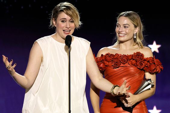 Greta Gerwig (with Margot Robbie) accepts the Best Director Award for 'Barbie' onstage during the 29th Annual Critics Choice Awards at Barker Hangar on January 14, 2024 in Santa Monica, California.