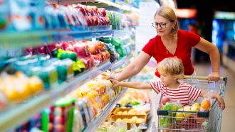 A woman and a child shop for groceries.