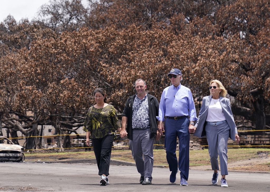 President Joe Biden and first lady Jill Biden walk with Hawaii Gov. Josh Green, second from left, and his wife Jaime Green