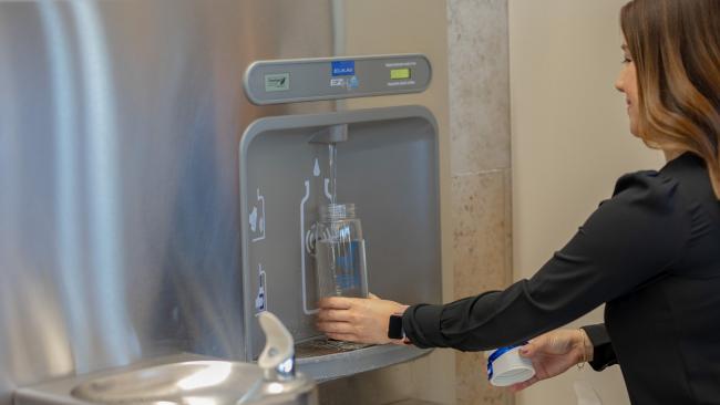 Refilling bottle at water station