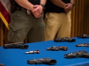 Guns recovered by the NYPD are displayed during a press conference