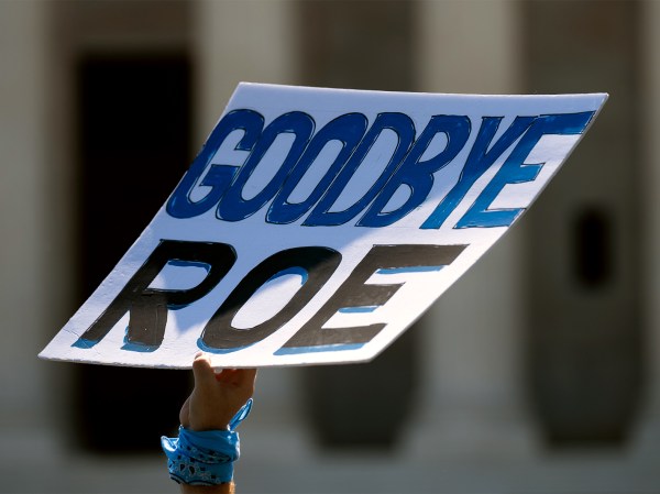 A demonstrator holds a sign that reads "Goodbye Roe" outside the US Supreme Court