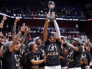 Las Vegas Aces' A'ja Wilson holds up the championship trophy