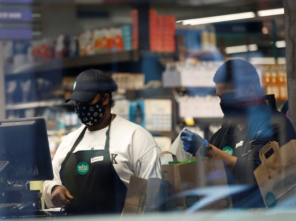 Two workers are seen in a food market in Washington, D.C.