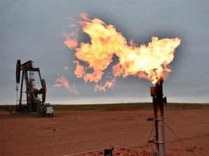 A flare burns natural gas at an oil well