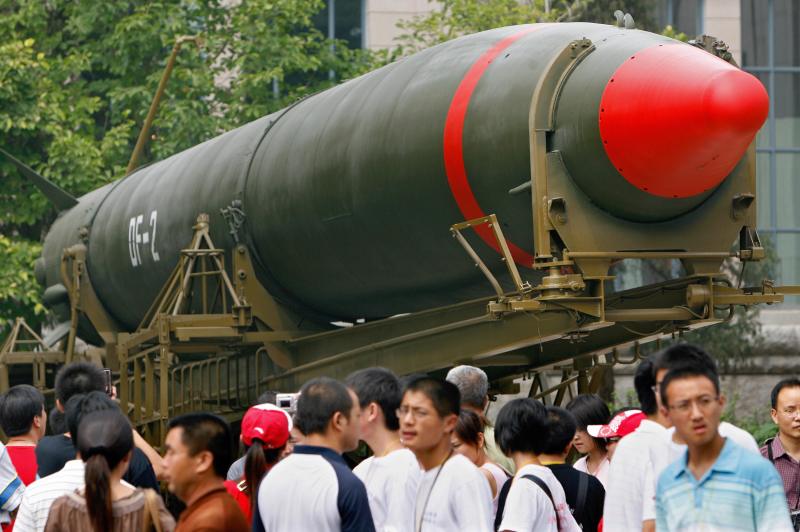 Visitors walk past China's second nuclear missile on display as they visit the Military Museum in Beijing, 23 July 2007.