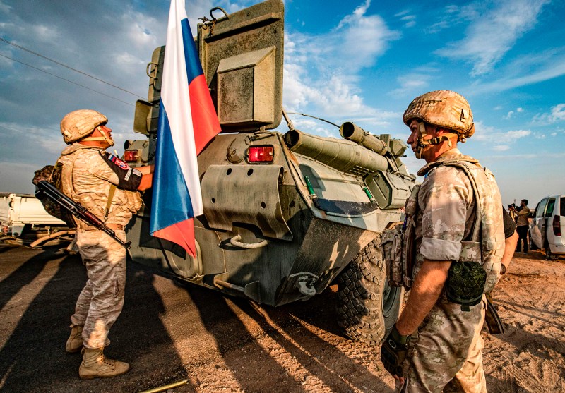 Russian military police stand near an armored personnel carrier in Syria's Hasakeh province on Oct. 24, 2019.