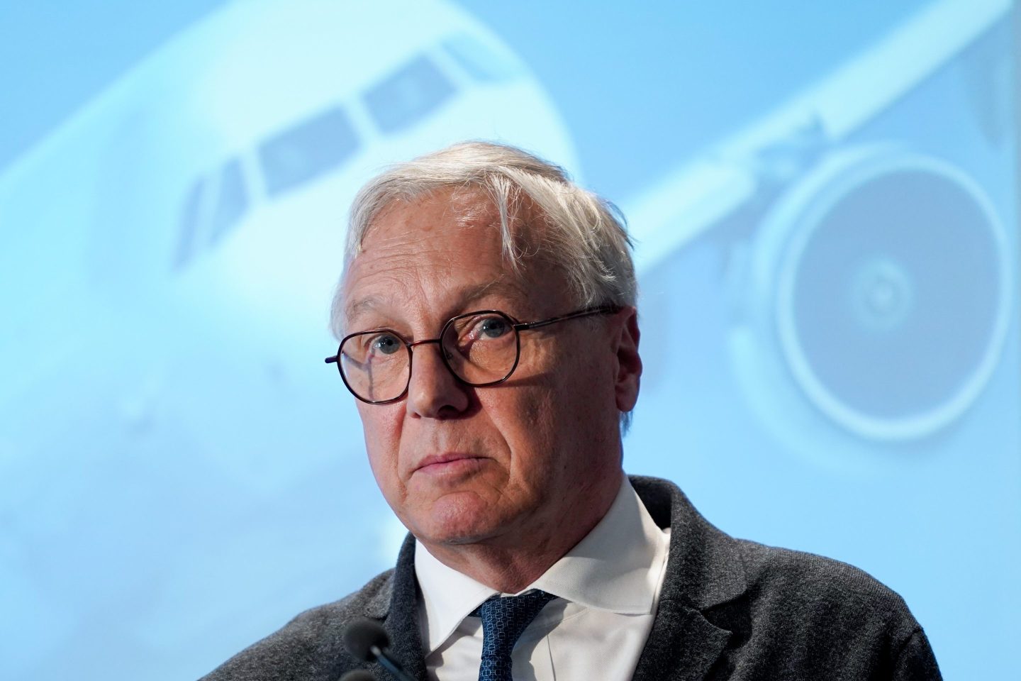 Christian Scherer with a picture of an aircraft behind him