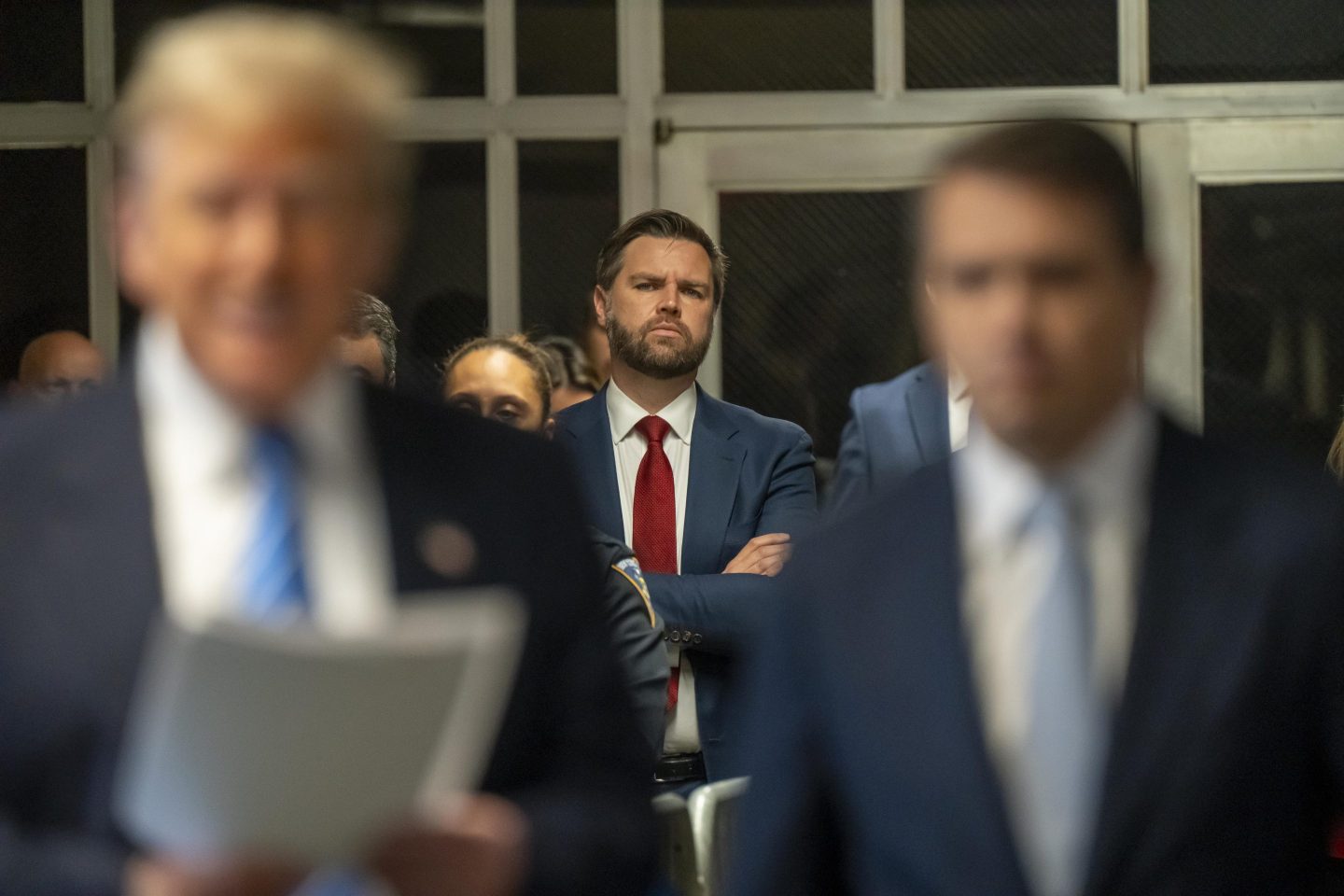 NEW YORK, NEW YORK - MAY 13: U.S. Sen. JD Vance (R-OH) looks on as former President Donald Trump speaks to the media during Trump&#039;s trial for allegedly covering up hush money payments at Manhattan Criminal Court on May 13, 2024 in New York City. Trump faces 34 felony counts of falsifying business records in the first of his criminal cases to go to trial.  (Photo by Mark Peterson-Pool/Getty Images)