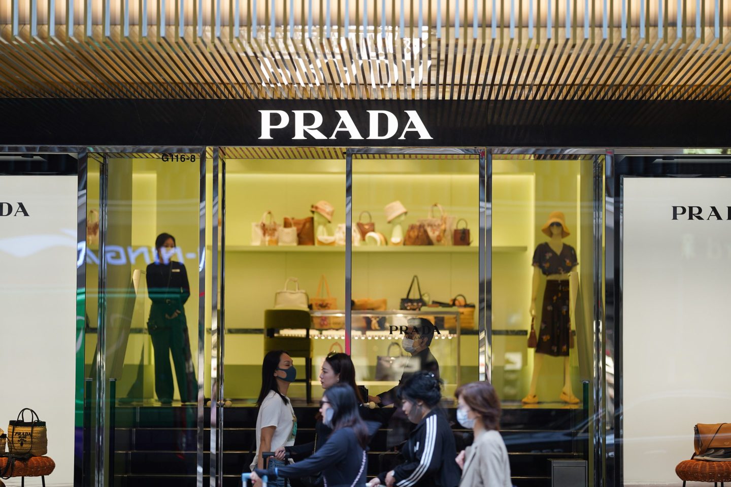 HONG KONG, CHINA &#8211; 2024/06/19: Pedestrians walk past the Italian multinational luxury fashion store Prada logo and store at Harbour City in Hong Kong. (Photo by Serene Lee/SOPA Images/LightRocket via Getty Images)