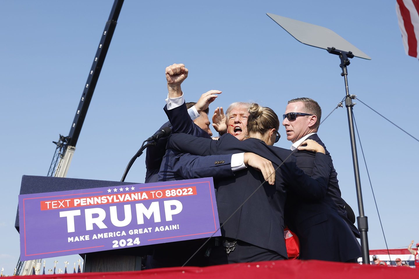 BUTLER, PENNSYLVANIA - JULY 13: Republican presidential candidate former President Donald Trump is rushed offstage during a rally on July 13, 2024 in Butler, Pennsylvania. Butler County district attorney Richard Goldinger said the shooter is dead after injuring former U.S. President Donald Trump, killing one audience member and injuring another in the shooting. (Photo by Anna Moneymaker/Getty Images)