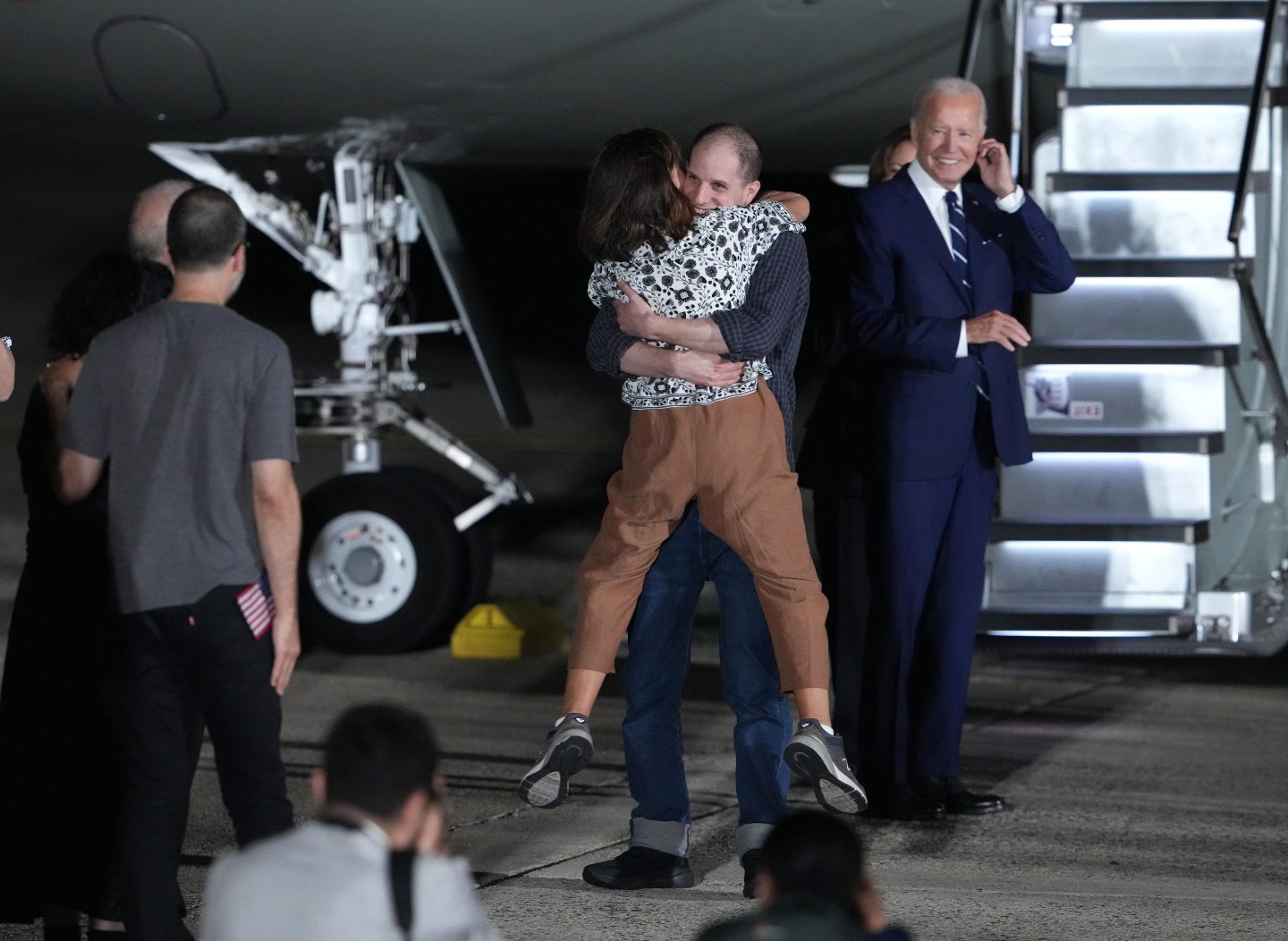 Evan Gershkovich greets his mother Ella Milman after he arrived back in the United States as President Joe Biden looks on on AuG. 1. His release, negotiated as part of a 24-person prisoner exchange with Russia that involved at least six countries, is the largest prisoner exchange in post-Soviet history.