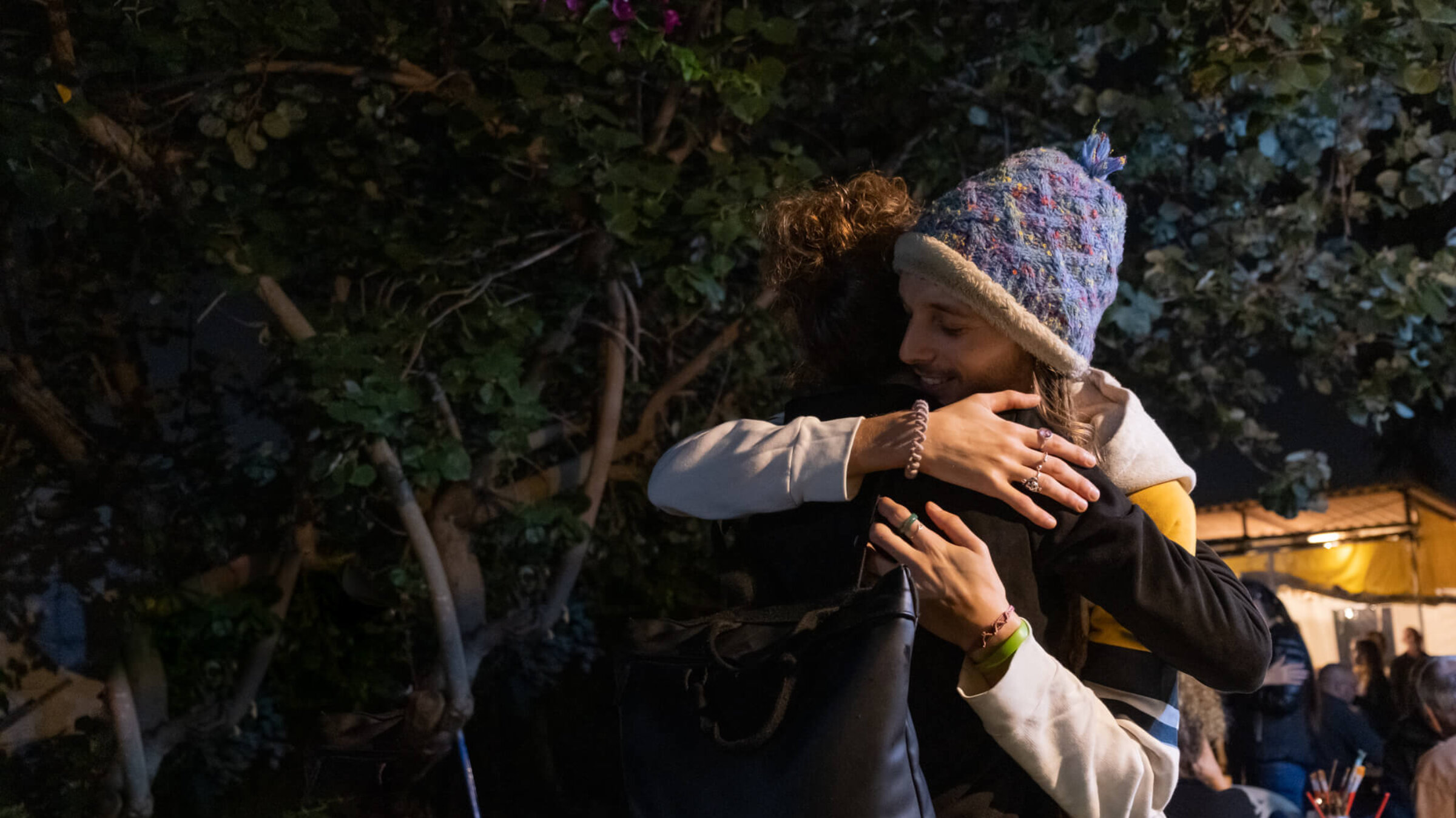 Survivors of the Nova Music Festival massacre embrace at Adama Tova.