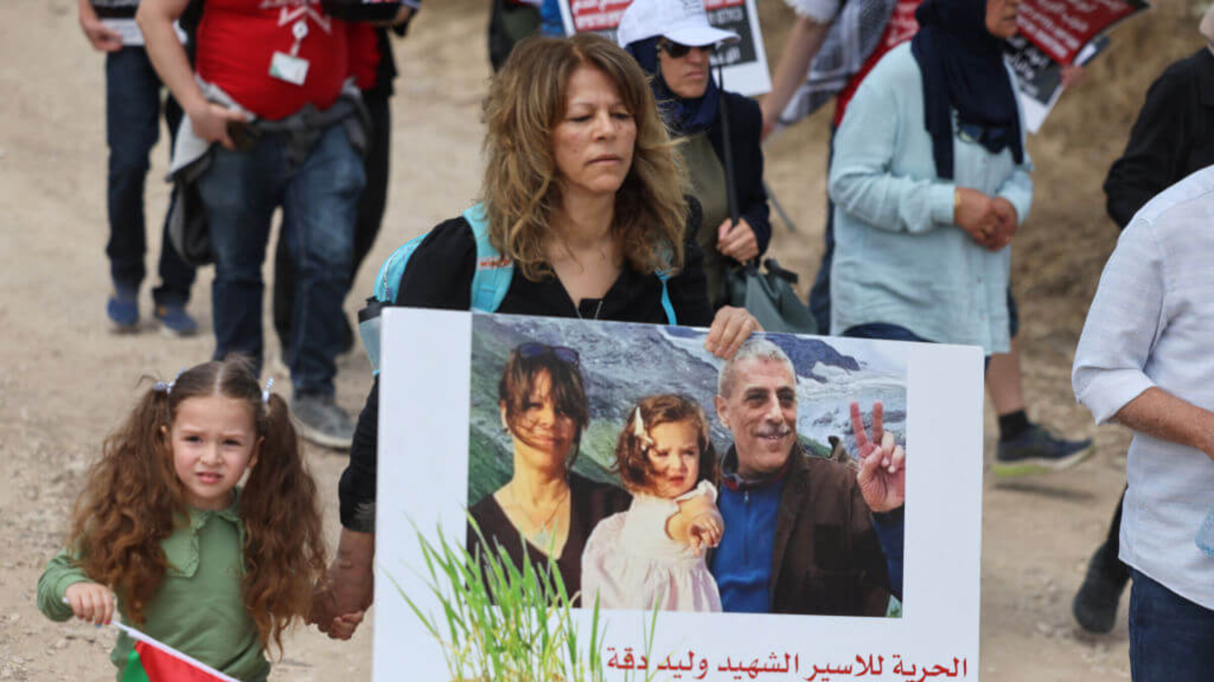 Sanaa Salameh, the wife of Walid Daqqa, and their daughter, Milad, attend a rally commemorating the anniversary of the Nakba following Walid's death. 