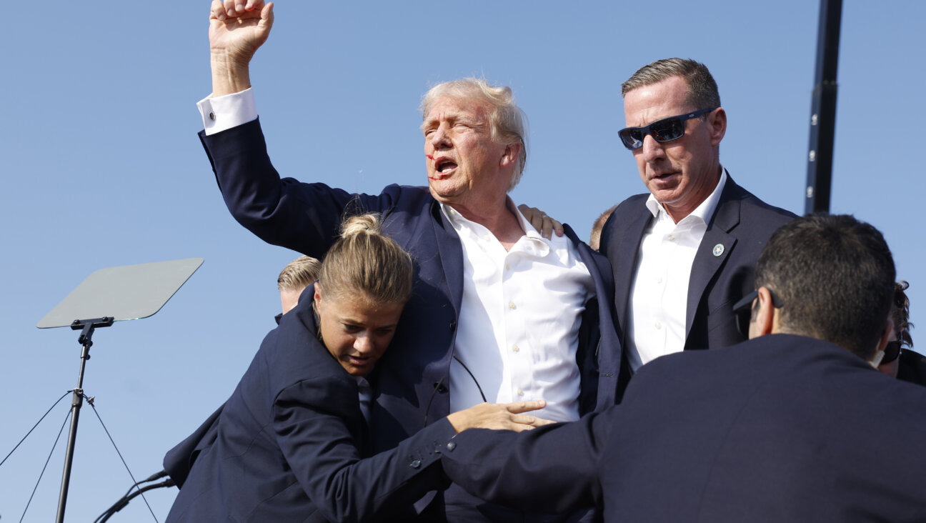 Republican presidential candidate and former President Donald Trump is rushed offstage by U.S. Secret Service agents after being grazed by a bullet during a rally on July 13, 2024 in Butler, Pennsylvania