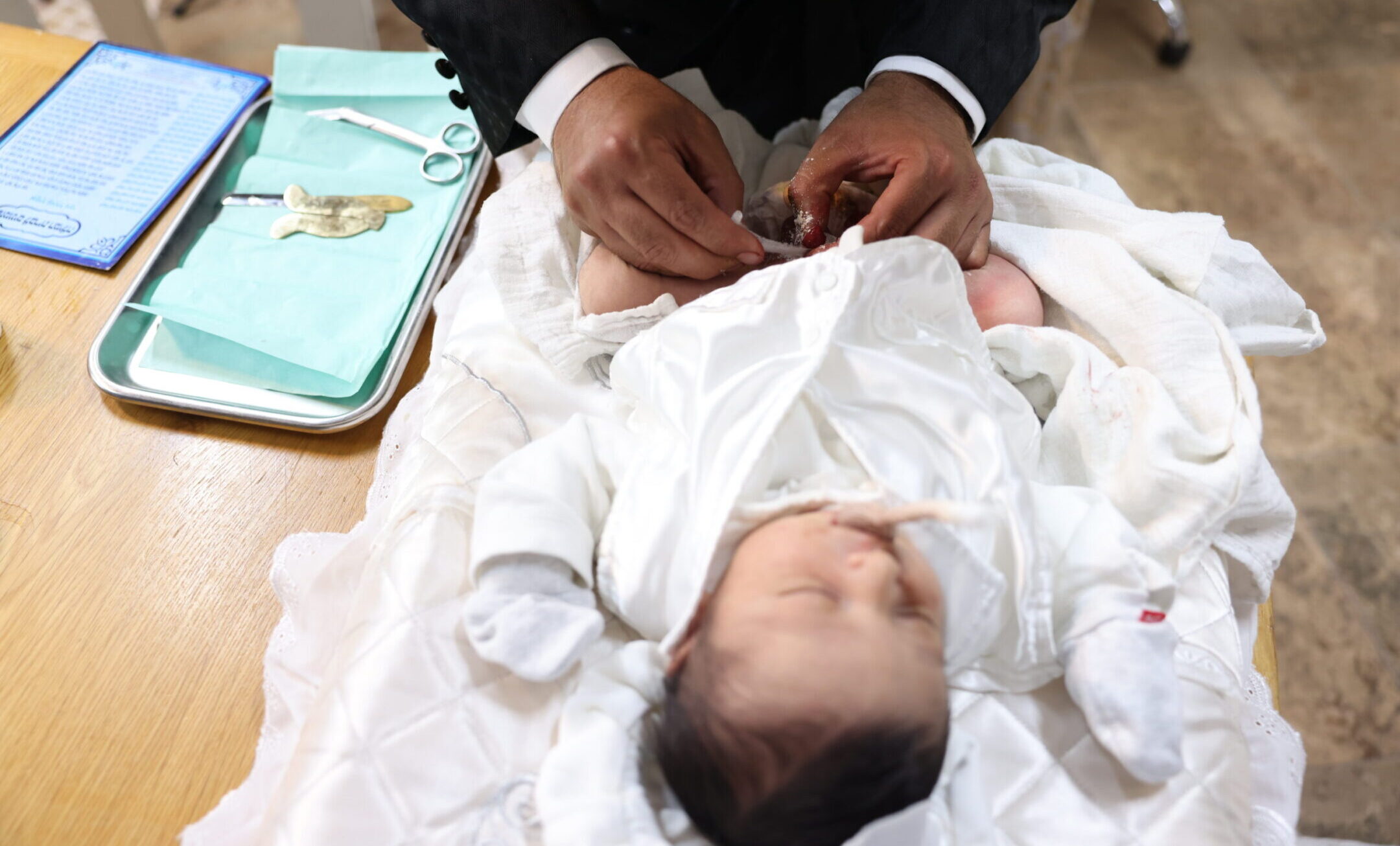 A mohel performs a circumcision ceremony in Israel, July 6, 2023. (David Cohen/Flash 90)