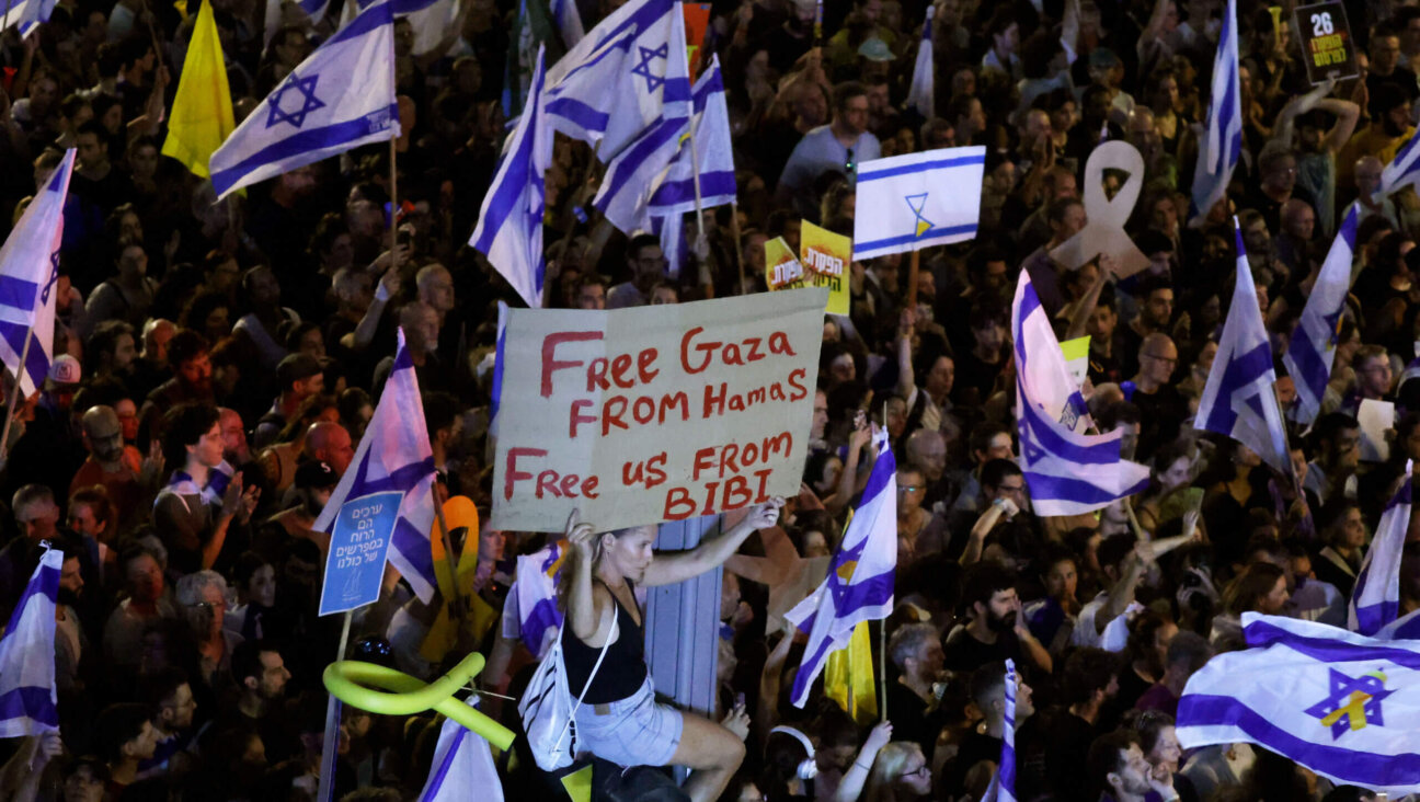 A protester holds up a sign as they join a crowd gathered to demand a deal to bring home hostages from Gaza, Sept. 1, Tel Aviv, Israel. 