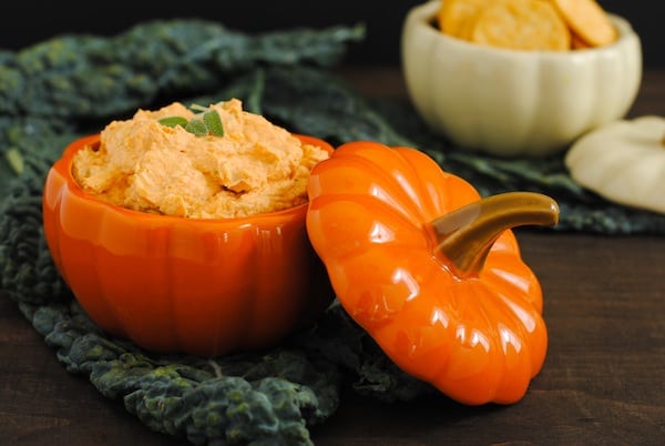 Light orange creamy dip in a small orange ceramic gourd.