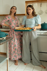 isadora with teal oven pan in kitchen