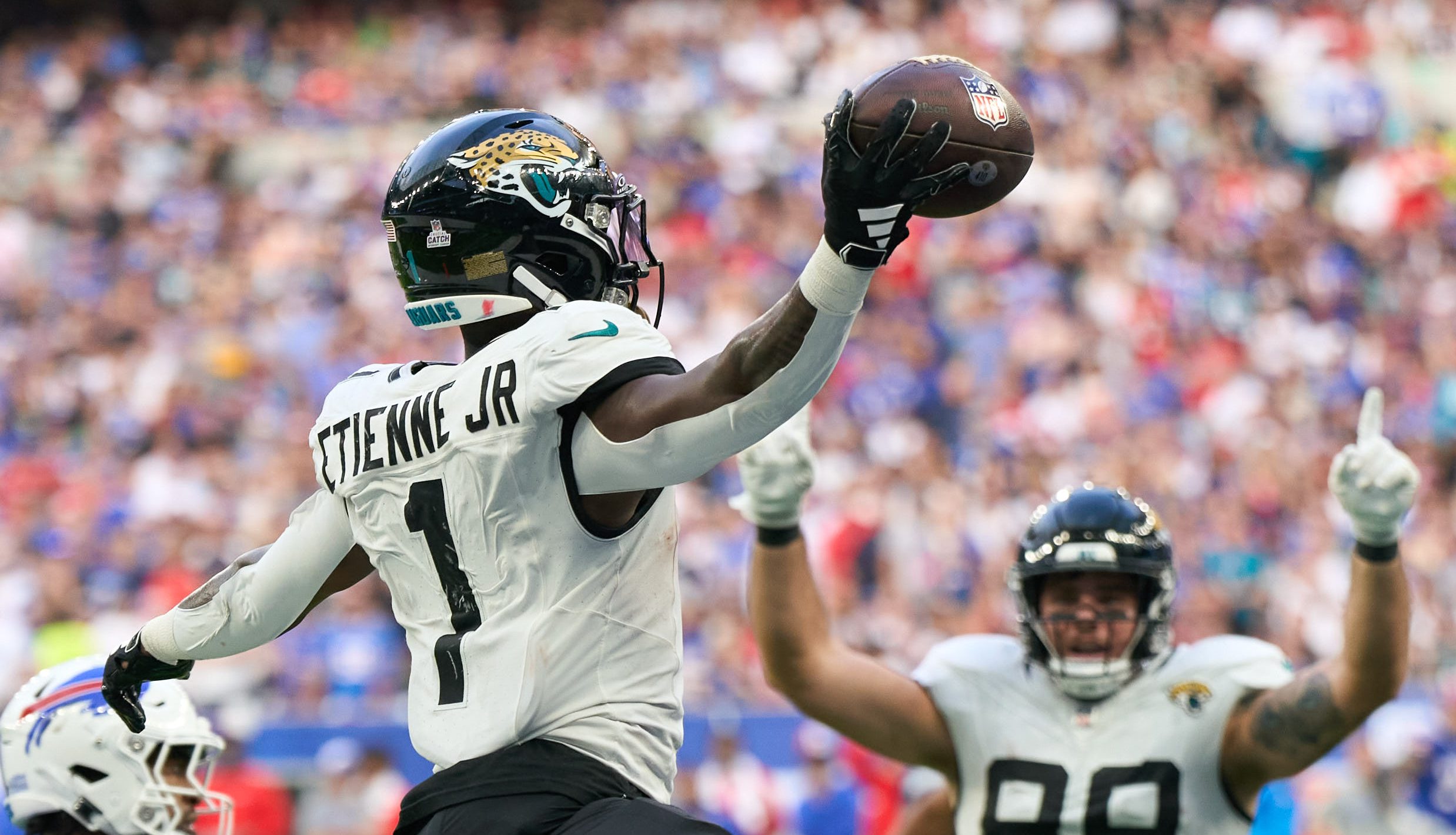 Oct 8, 2023; London, United Kingdom; Jacksonville Jaguars running back Travis Etienne Jr. (1) jumps into the end zone for a touchdown during the second half of an NFL International Series game against the Buffalo Bills at Tottenham Hotspur Stadium.