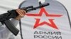 CRIMEA – A woman holds a mock-up of an AK-74 Kalashnikov assault rifle at a mobile recruitment centre, Simferopol, 15Apr2023