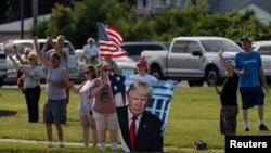 Supporters react as Trump Force One, carrying Republican presidential candidate and former U.S. President Donald Trump, lands in Milwaukee, Wisconsin, a day after he survived an assassination attempt at a rally in Butler, Pennsylvania.