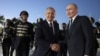  Uzbek President Shavkat Mirziyoev (left) welcomes Russian President Vladimir Putin at Tashkent's airport in May. 