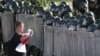 A protester faces riot police during an anti-government demonstration in Minsk in September 2020.