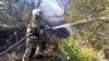 A handout photo from the Russian Emergencies Ministry shows a firefighter at the scene of a fire near Khutor Dyurso, in southern Russia, on July 14. 