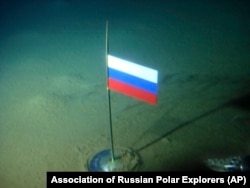 A titanium capsule with the Russian flag is seen seconds after it was planted by the Mir-1 minisub on the Arctic Ocean seabed under the North Pole during an August 2007.