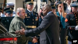 U.S. Defense Secretary Lloyd Austin (right) greets Ukrainian Defense Minister Rustem Umerov at the Pentagon in Washington, D.C., on July 2.