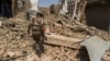 In the town of Miran Shah, North Waziristan, a Pakistani soldier inspects the site of a house destroyed during a military operation against Taliban militants in 2014.