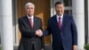 Chinese leader Xi Jinping (right) is greeted by Kazakh President Qasym-Zhomart Toqaev in Astana on July 2 for a state visit ahead of a two-summit for the Shanghai Cooperation Organization.