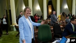 FILE - Assemblywoman Buffy Wicks, D-Oakland, smiles after measure that would force Big Tech companies to pay media outlets for using their news content was approved by the Assembly at the Capitol in Sacramento, Calif., June 1, 2023.