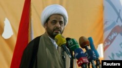 Qais al-Khazali, leader of Iraq's Shi'ite militia Asaib Ahl al-Haq, speaks to supporters during a parade in Karbala, March 21, 2014. 