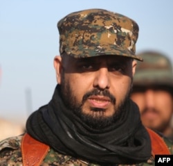 Qais al-Khazali, leader of the Shiite militia Asaib Ahl al-Haq (The League of the Righteous), looks on as he stands in the area of Albu Ajil, east of the northern city of Tikrit on March 7, 2015, during a military operation to retake the Tikrit area. Iraq
