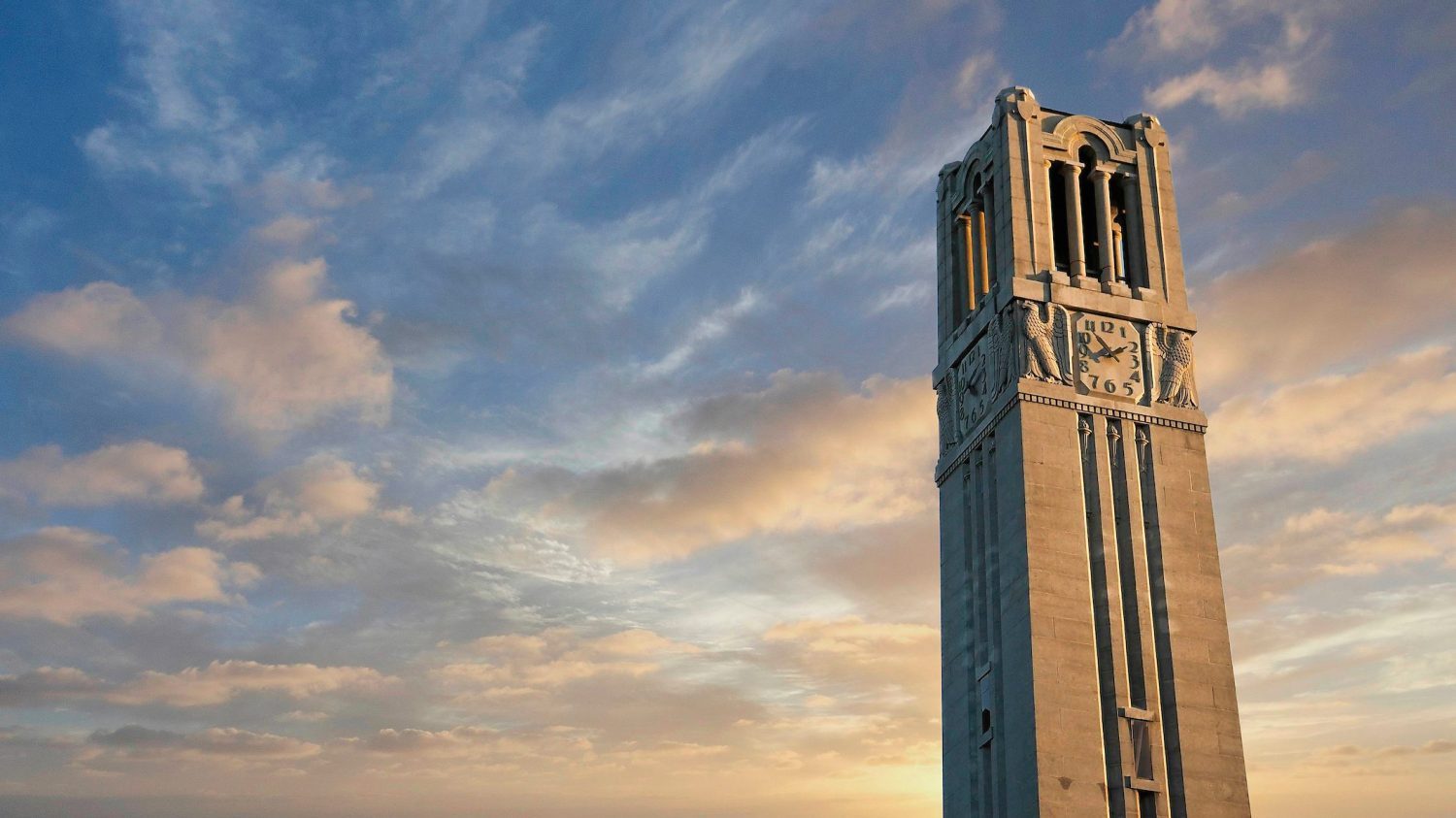 The top of the belltower against the early evening sky.