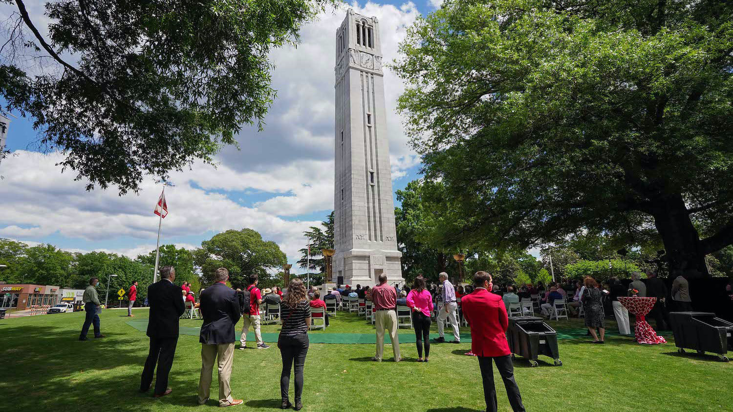 An audience gathering to witness the reopening of the Memorial Belltower and dedication of Henry Square.