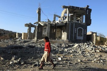 A girl walks through the rubble of war in Sana'a, Yemen.