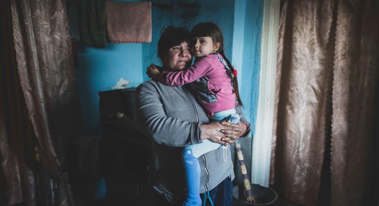 A woman holds her daughter in her house located right at the “contact line” in Ukraine. (file)