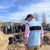 A UN staffer stands in front of a mass grave site in Bucha, Ukraine. In the background the United Nations Emergency Relief Coordinator Martin Griffiths.