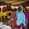 Women line up to receive beneficiary cards to buy fortified flour to prevent malnutrition in Kongoussi, Burkina Faso.